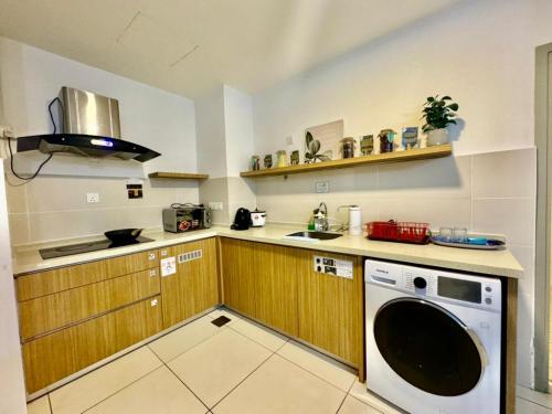 a kitchen with a washing machine and a sink at SA Sutera Avenue Homestay Opposite Imago KK in Kota Kinabalu
