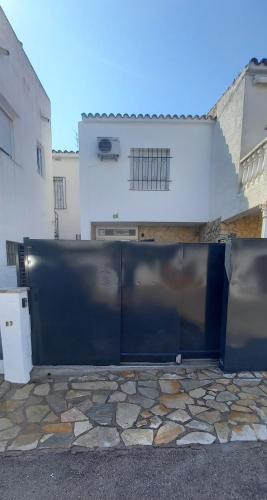 a large black gate in front of a building at Empuriabrava 500m de la plage de la Rubina in Empuriabrava