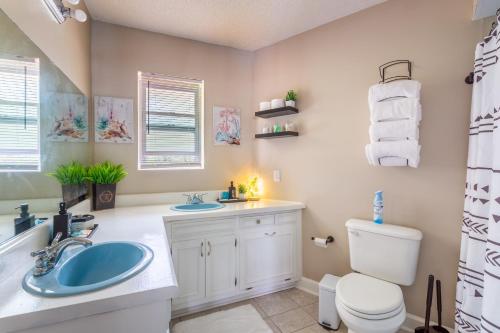 a bathroom with a sink and a toilet at Golden Isles Lrge Home- Huge Pool, Hot Tub, Game Rm in Brunswick