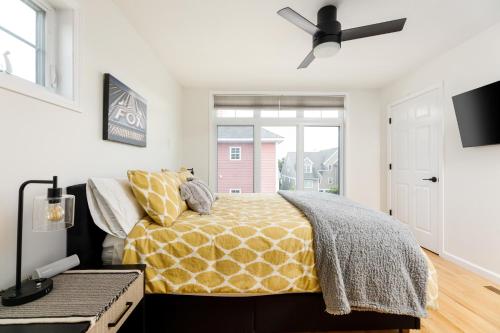 a bedroom with a bed and a ceiling fan at Midtown Modern - urban condo walkable to bars and beach in Traverse City