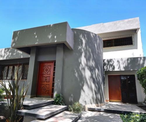 ein weißes Haus mit einer braunen Tür und einer Treppe in der Unterkunft Casa en la mejor ubicación! in Mendoza