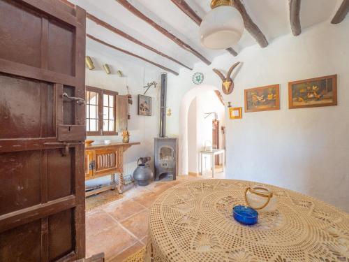 a large room with a table and a fireplace at Cubo's Cortijo El Perezon in Archidona