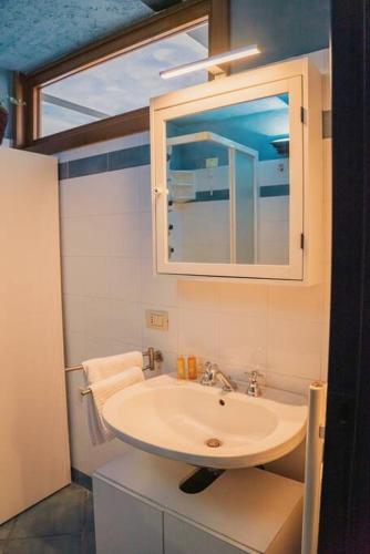a bathroom with a sink and a mirror at Suite Cielo - Lago di Como in Blevio
