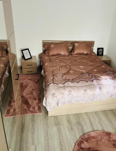 a bedroom with a large bed and a wooden floor at Luana & Priam home in Petrila