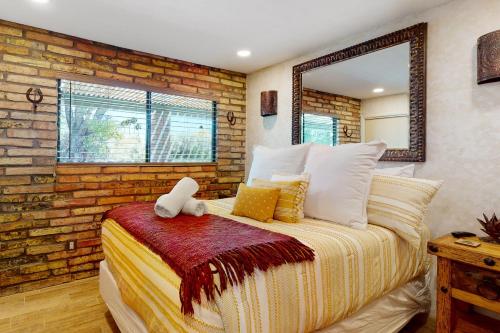 a bedroom with a bed and a brick wall at Tranquil Trail #6 in Carefree