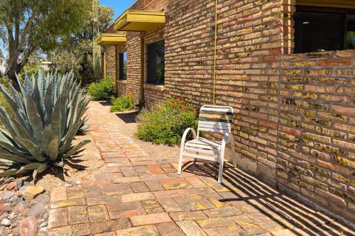 a chair sitting in front of a brick building at Tranquil Trail #6 in Carefree