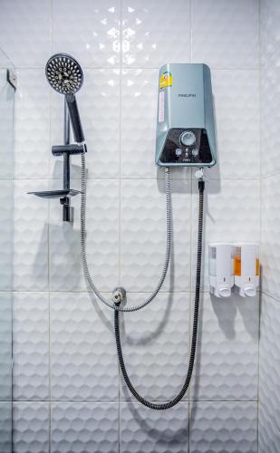 a shower in a bathroom with a shower head at Villa loved beach AO Nam Mao krabi in Ao Nam Mao