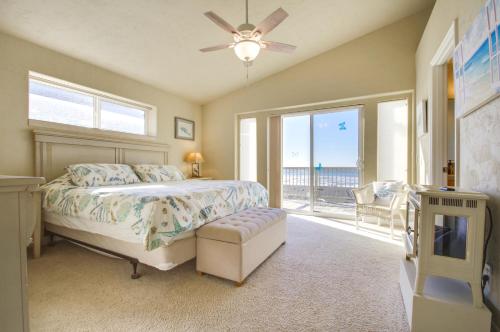 a bedroom with a bed and a tv and a window at Quiet Waterfront Escape with Hot Tub and Beach Access! in Gold Beach