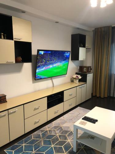 a living room with a large flat screen tv on the wall at Adrian Home 3 rooms apartment in Ploieşti