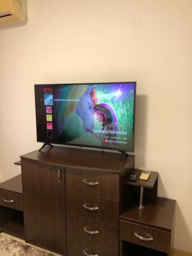 a flat screen tv sitting on top of a dresser at Adrian Home 3 rooms apartment in Ploieşti