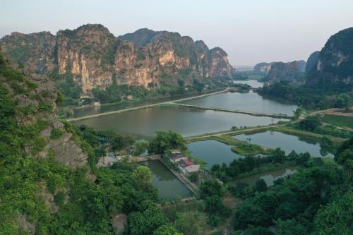 an aerial view of a river between two mountains at Trang An Pristine View homestay in Ninh Binh
