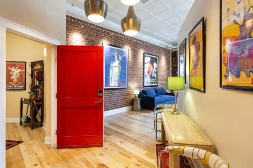 a room with a red door and a blue chair at Penthouse Apartment Overlooking Downtown Mall in Charlottesville