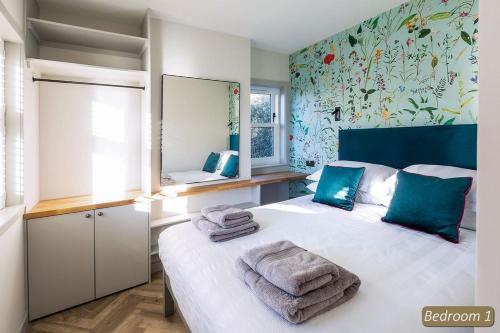 a bedroom with a bed with towels on it at Station Cottage in North Berwick