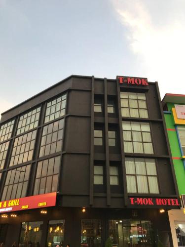 a large black building with a t max hotel at T-MOK Hotel in Sepang