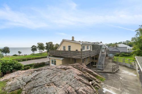 an aerial view of a house with a large rock at Cozy Holiday Apartment In Allinge in Allinge