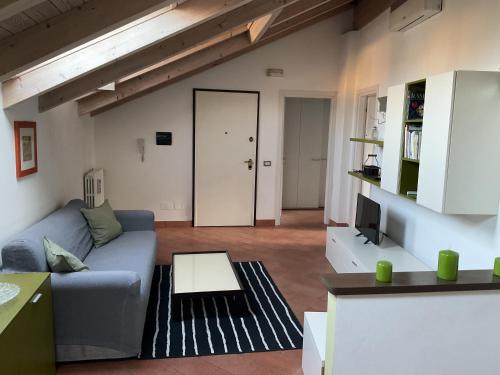 a living room with a couch and a tv at Mansarda nel cuore di Novi in Novi Ligure