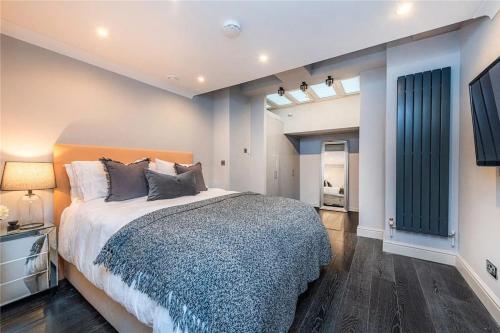 a bedroom with a large bed and a television at The Marylebone Goldmine in London
