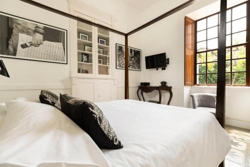 a bedroom with two white beds and a window at The El Paso in El Paso