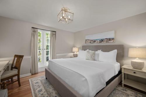 a bedroom with a bed and a desk and a chair at Hamilton Turner Inn in Savannah