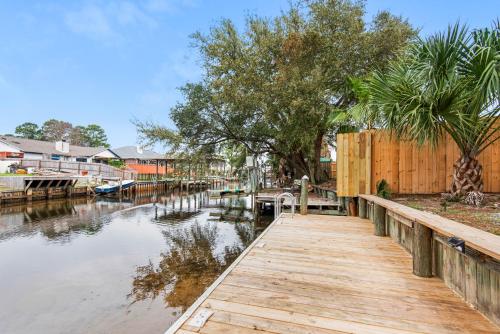 a wooden dock next to a body of water at Gulf Brz-Beaches-Dwntwn PNS-Pet Friendly-Canal in Gulf Breeze