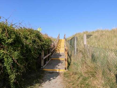 a stairway up to the top of a hill with a fence at White Rabbit, Cross Lane in Norwich