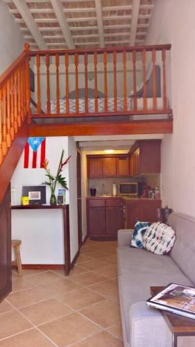 a living room with a staircase and a couch at Old San Juan Historic Loft 4 The Adventurous in San Juan