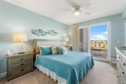 een slaapkamer met een bed en een raam met een balkon bij Laketown Wharf #422 by Nautical Properties in Panama City Beach