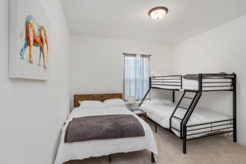 a bedroom with a bed and a bunk bed at Chic Townhouse by LSU in Baton Rouge