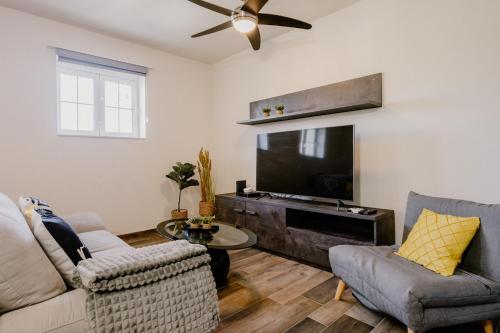 a living room with a couch and a tv at LA88 Bayview Rooms in Sliema
