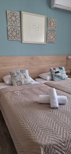 two beds with towels on them in a bedroom at Art Blue Apartments in Ohrid