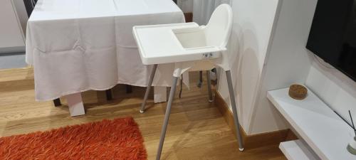 a white table with a white sink next to a table at MODERN BILBAO in Barakaldo