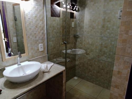 a bathroom with a sink and a shower at Gostoso Sol e Mar Pousada in São Miguel do Gostoso