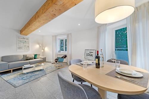 a living room with a table and a couch at Abitaziun Sur Ovel - St Moritz "LOGA ELEGANCE APARTMENT" in St. Moritz
