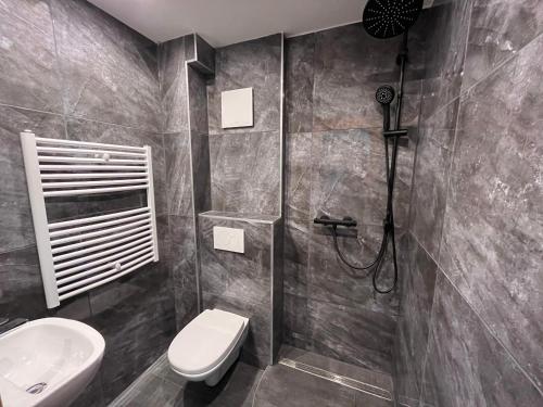 La salle de bains est pourvue d'une douche, de toilettes et d'un lavabo. dans l'établissement Pension Rexha am Weißensee, à Füssen