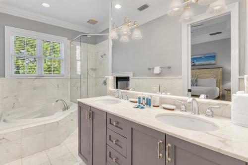 a white bathroom with two sinks and a tub and a tubermott at Le Jardin 168 - 3BR 3.5BA - (10) in Destin