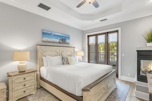 a bedroom with a bed and a fireplace at Le Jardin 168 - 3BR 3.5BA - (10) in Destin