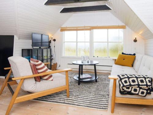 a living room with a couch and a table at 5 person holiday home in Allingåbro-By Traum in Allingåbro