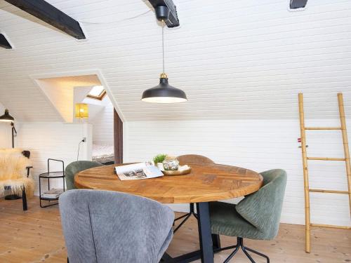 a dining room with a wooden table and chairs at 5 person holiday home in Allingåbro-By Traum in Allingåbro