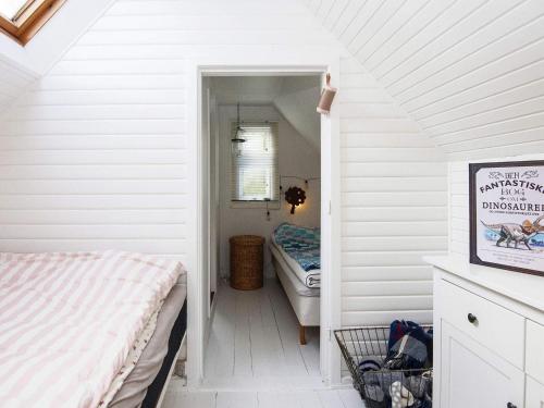 a bedroom with two beds in a white room at 5 person holiday home in Allingåbro-By Traum in Allingåbro