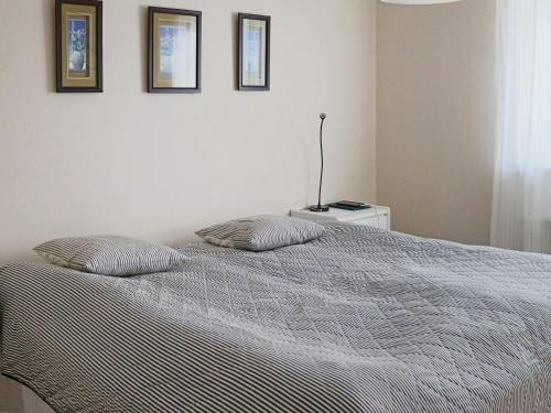 a bedroom with a bed with two pillows on it at 4 person holiday home in HYLTEBRUK-By Traum in Hyltebruk