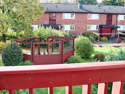 a red wooden fence in front of a building at 4 person holiday home in HYLTEBRUK-By Traum in Hyltebruk