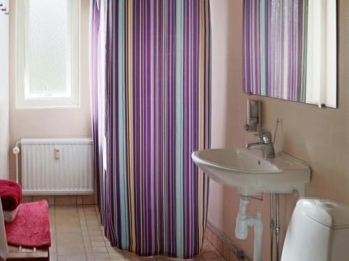 a bathroom with a sink and a shower curtain at 4 person holiday home in HYLTEBRUK-By Traum in Hyltebruk