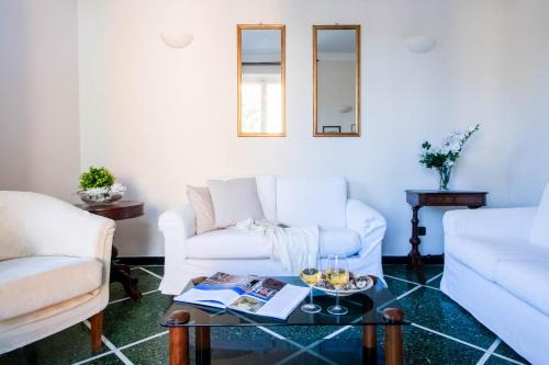 a living room with two white couches and a table at Daisy by PortofinoHomes in Santa Margherita Ligure