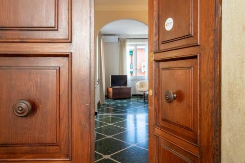a hallway with a wooden door and a living room at Daisy by PortofinoHomes in Santa Margherita Ligure