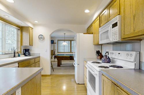 a kitchen with white appliances and a white refrigerator at 12 Whistler in Sunriver