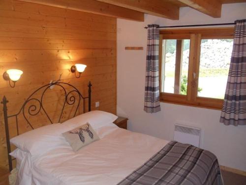 1 dormitorio con cama y ventana en Chalet Chocolat Chatel en Châtel