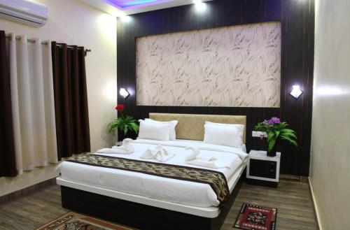 a bedroom with a large bed in a room at HOTEL MARIYA INTERNATIONAL in Bodh Gaya