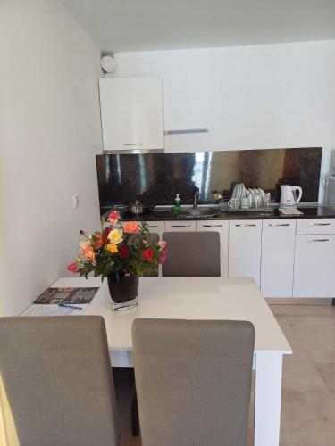 a kitchen with a table with a vase of flowers on it at SAPPHIRE in Sozopol