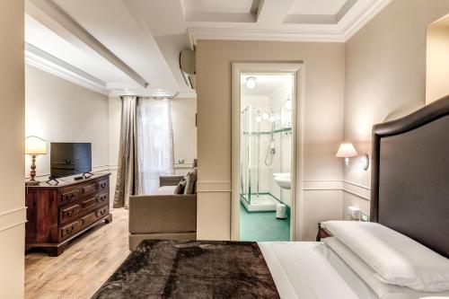 a bedroom with a bed and a bathroom at Aurelius Ponte Sant'Angelo in Rome