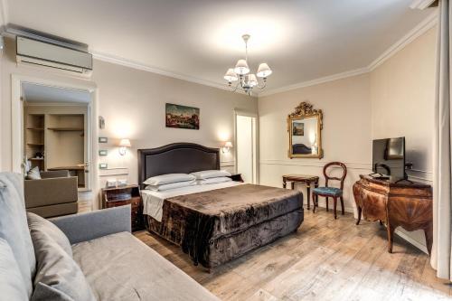 a bedroom with a bed and a desk and a couch at Aurelius Ponte Sant'Angelo in Rome